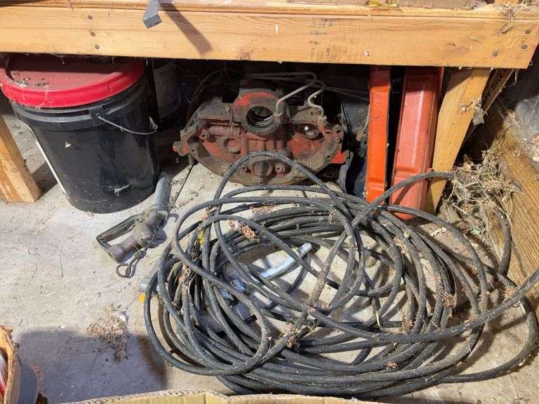 Bucket of hydraulic oil, extension cord, gas nozzles, and more
