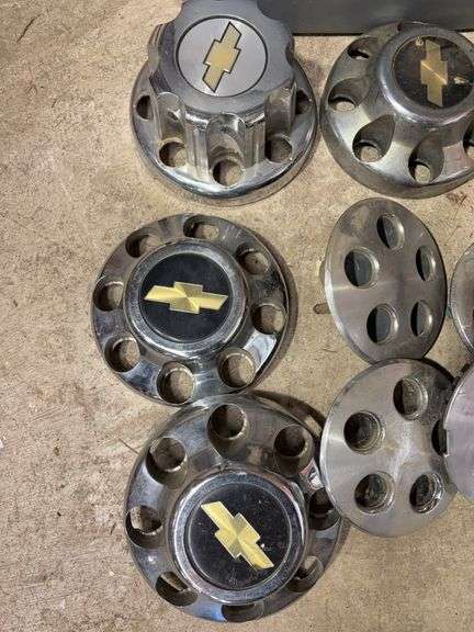 Tote of Chevy hub caps and parts