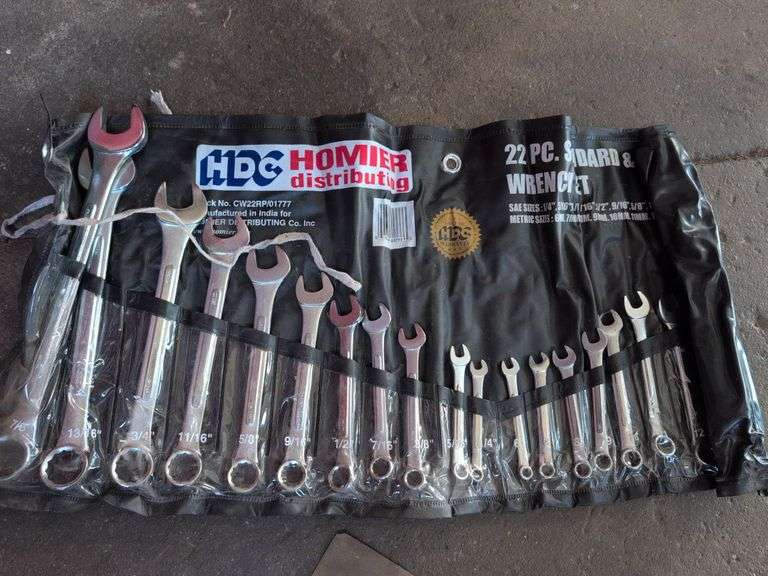 Assortment of tools - battery charger, staple gun, sockets, and more