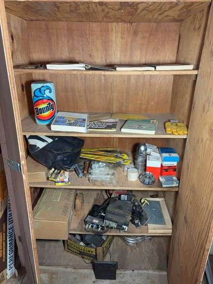 Contents of cabinet - oil filters, wiper blades, CB radios, manuals, and more