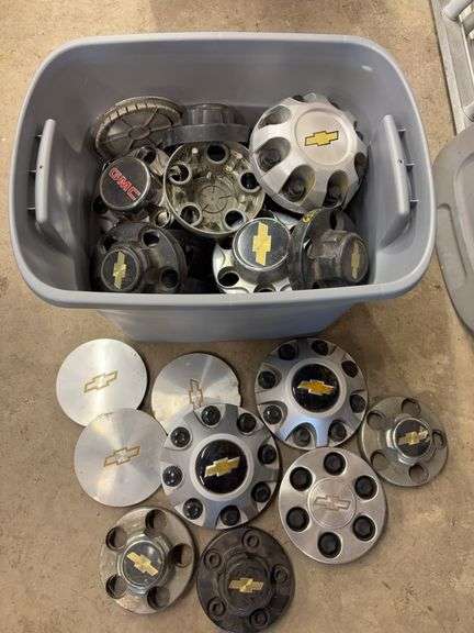 Tote of Chevy hub caps and parts