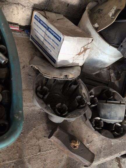 Contents of corner - car parts, center caps, and more