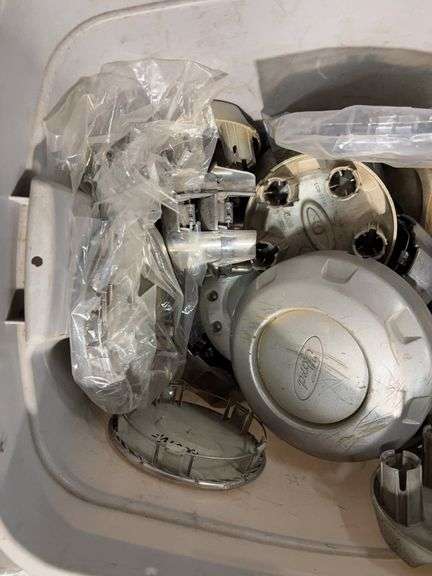 Tote of miscellaneous hubcaps - Buick, Honda, and more
