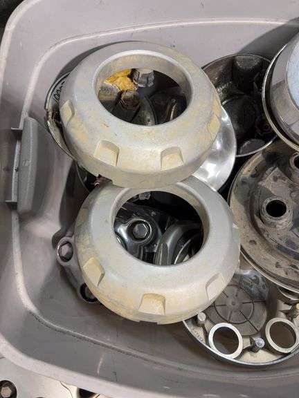 Tote of hub caps and parts -Nissan, Chevy, Ford and more