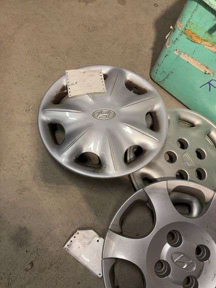 Large tote of hub caps and parts -Hyundai, Eagle and more
