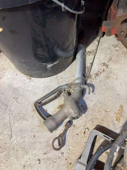Bucket of hydraulic oil, extension cord, gas nozzles, and more