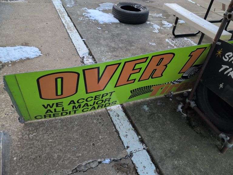 Large double-sided green metal sign - "Over 1000 tires in stock" - 8' x 28"