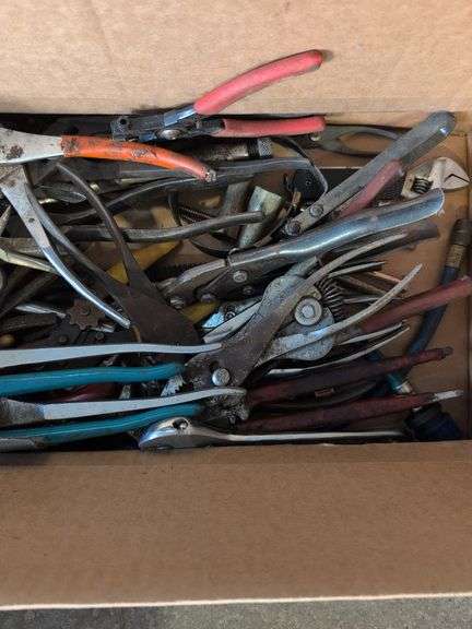 Box of tools - wrenches, pliers, grease gun, and more