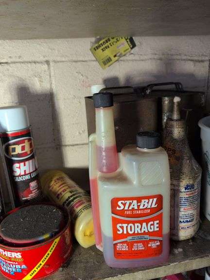 Shelf of cleaners, sprays, and other vehicle fluids