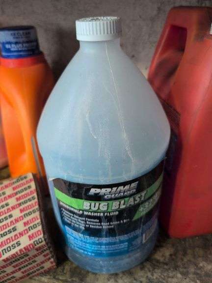 Shelf of shop rags and vehicle fluids