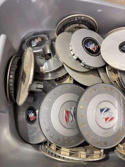 Tote of Buick hub caps and parts