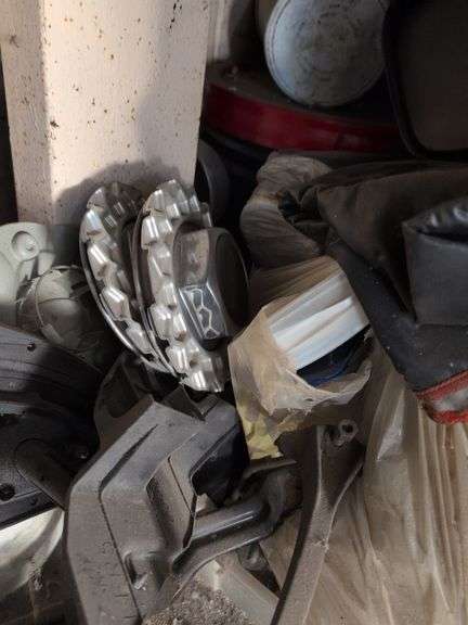 Contents of corner - car parts, center caps, and more