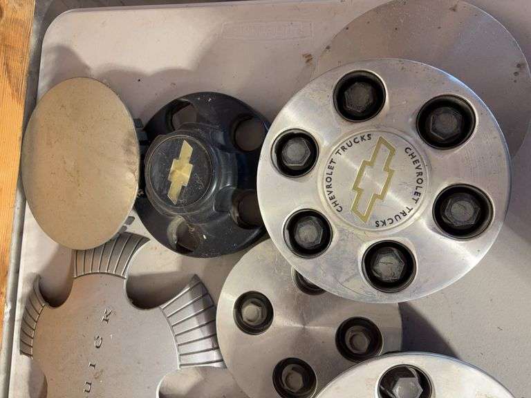 Tote of hub caps and parts -Chevy, Buick, and more