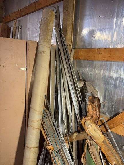 Corner of car parts and scrap metal pieces - as is