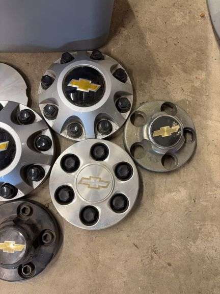 Tote of Chevy hub caps and parts