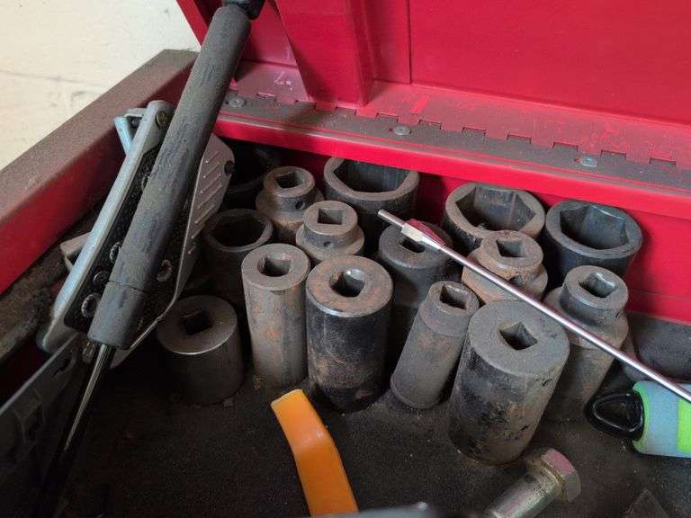 Assortment of tools - battery charger, staple gun, sockets, and more