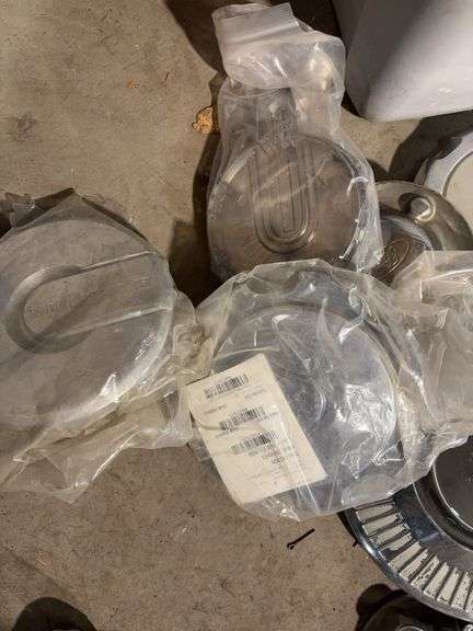 Tote of miscellaneous hubcaps - Buick, Honda, and more