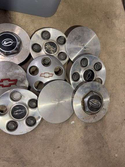 Tote of Chevy hub caps and parts