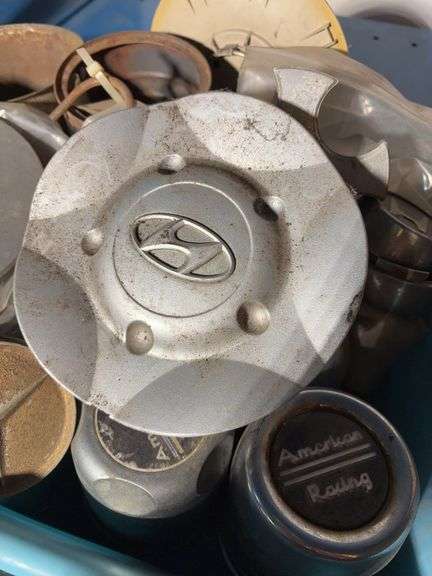 Tote of hub caps and parts, Jeep, Nissan, Toyota and more