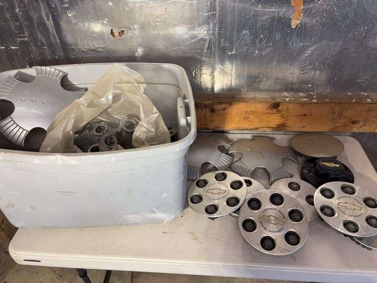 Tote of hub caps and parts -Chevy, Buick, and more