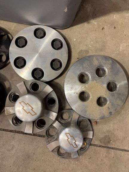 Tote of Chevy hub caps and parts
