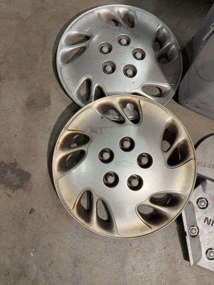 Tote of hub caps and parts -Nissan, Chevy, Ford and more
