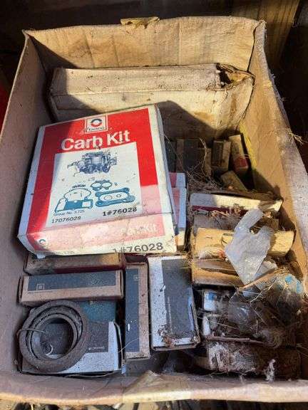 (2) shelves of vehicle-related items - sparkplugs, signs, and more