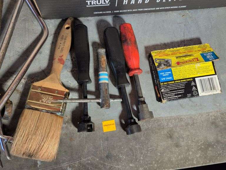 Flat of tools - staples, wrench, and more