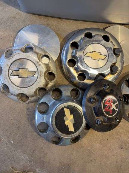Large tote of Chevy hub caps and parts