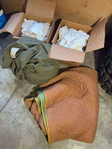 Boxes of rags, military bag, and blankets