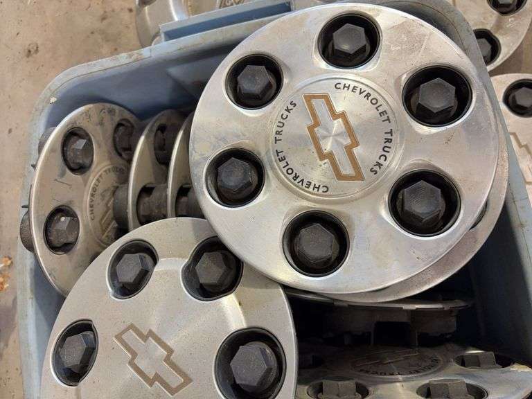 Tote of mostly Chevy hub caps and parts -see photos
