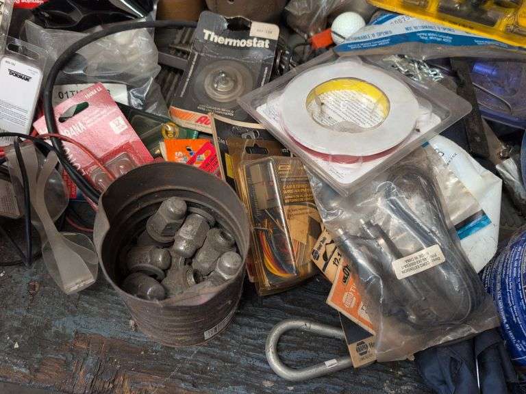 Assortment of items - tape, nuts and bolts, gloves, and more
