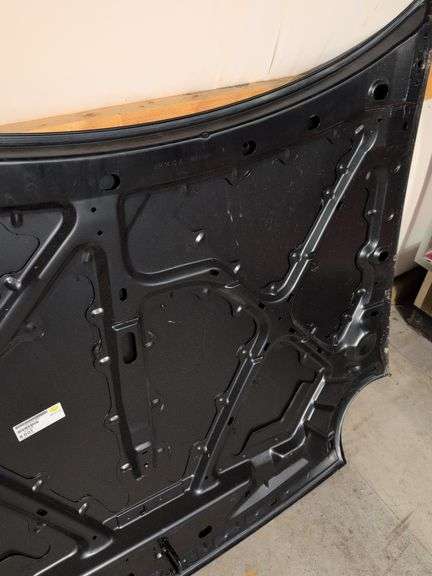 Unmarked black vehicle hood - see photos