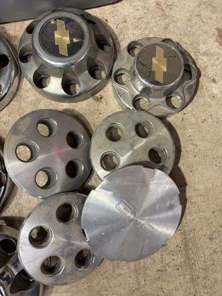 Tote of Chevy hub caps and parts