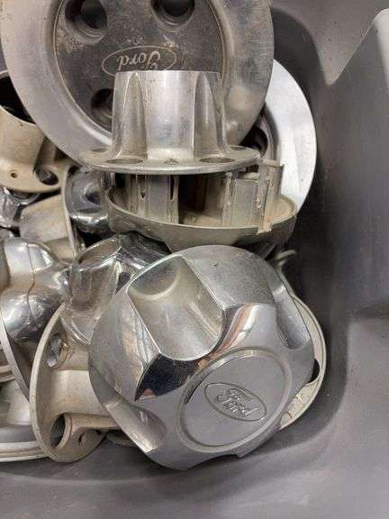Tote of Ford hub caps and parts