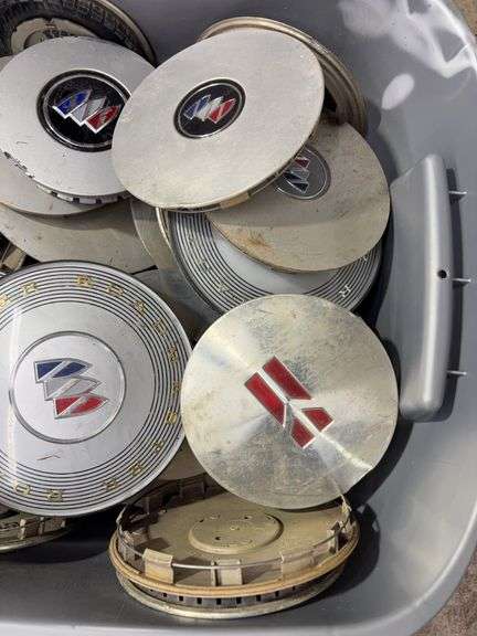 Tote of Buick hub caps and parts