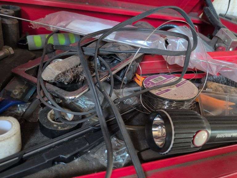 Assortment of tools - battery charger, staple gun, sockets, and more