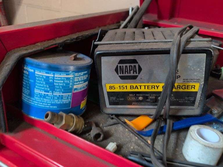 Assortment of tools - battery charger, staple gun, sockets, and more