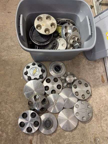 Tote of Chevy hub caps and parts