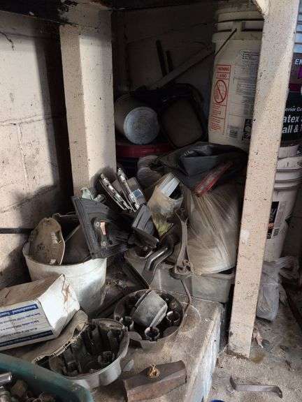 Contents of corner - car parts, center caps, and more
