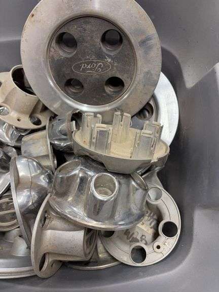 Tote of Ford hub caps and parts