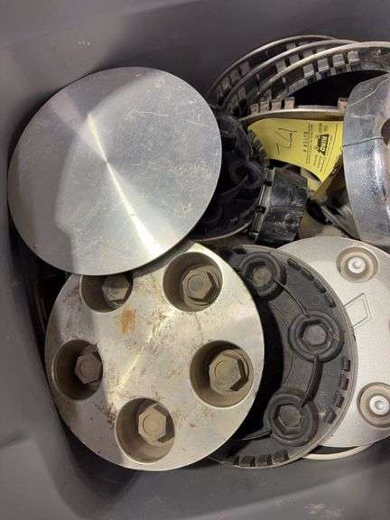 Tote of Chevy hub caps and parts