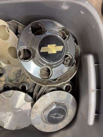 Tote of miscellaneous hub caps and parts -including Ford, Chevy and more - see photos