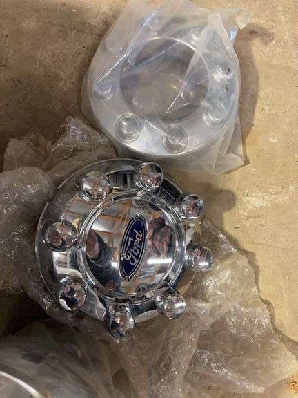 Tote of Ford, GMC, and Chevy hub caps and parts