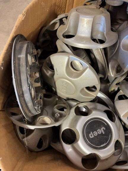 Assortment of hub caps including Jeep, Buick, and Chevy -see photos