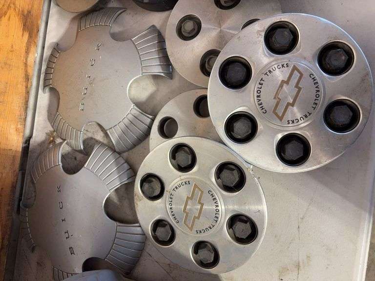 Tote of hub caps and parts -Chevy, Buick, and more