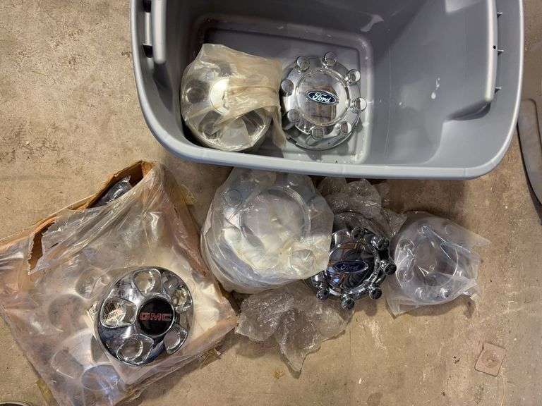 Tote of Ford, GMC, and Chevy hub caps and parts