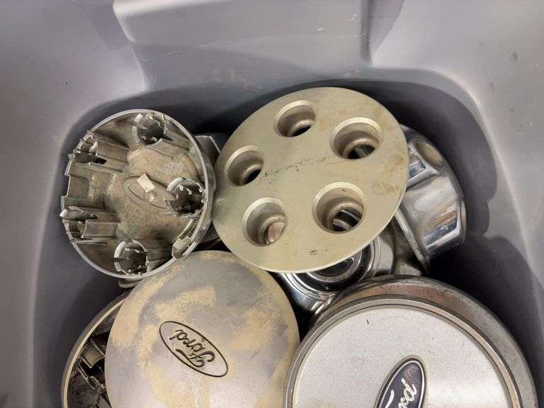 Tote of Ford hub caps and parts