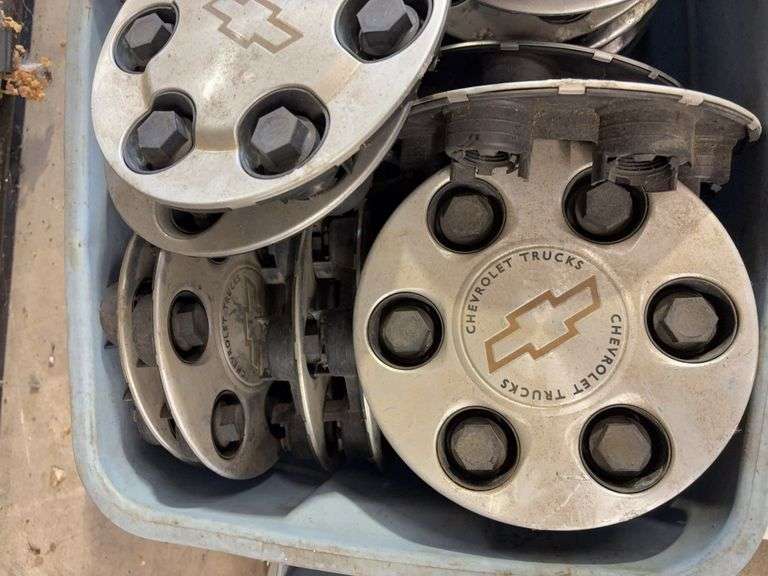 Tote of mostly Chevy hub caps and parts -see photos