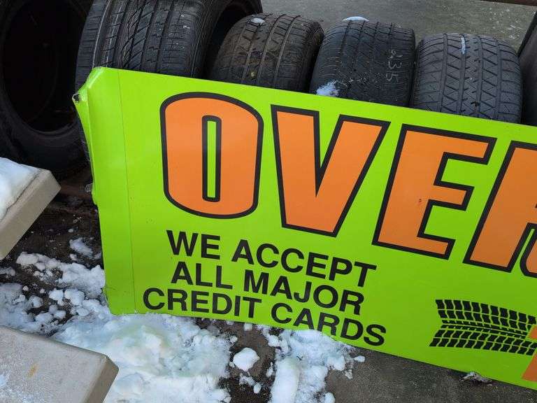 Large double-sided green metal sign - "Over 1000 tires in stock" - 8' x 28"